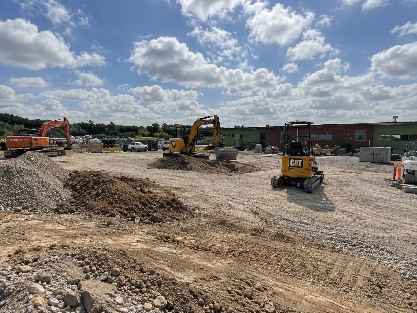 Excavator shaping a large commercial site in Christchurch